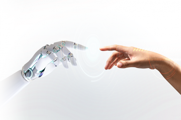 An artificial hand from the left and a human hand from the right are about to touch with the